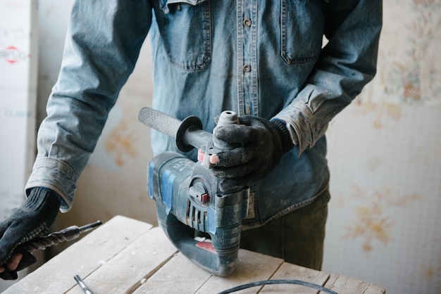 A man changes the bit on the punch