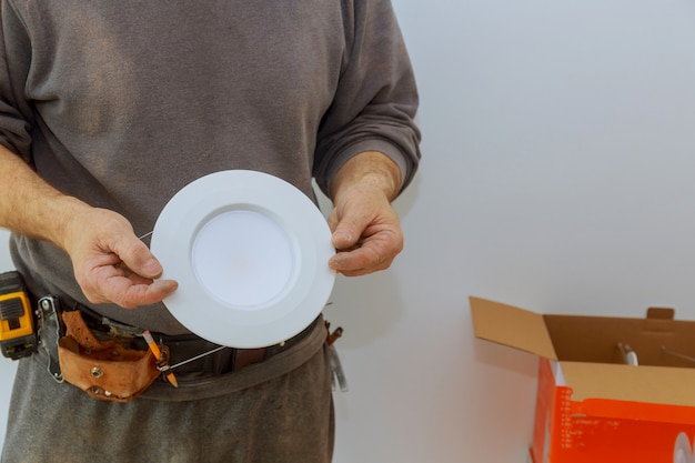 Man changing of LED light in new home