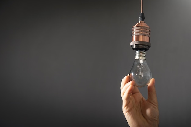 Man changing light bulb at home