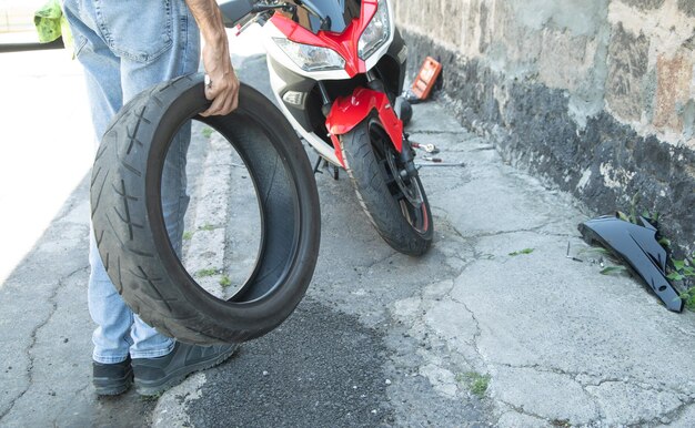 Man changing motorcycle tire Sport Hobby