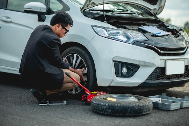 Man changing wheel after a car breakdown Transportation traveling concept