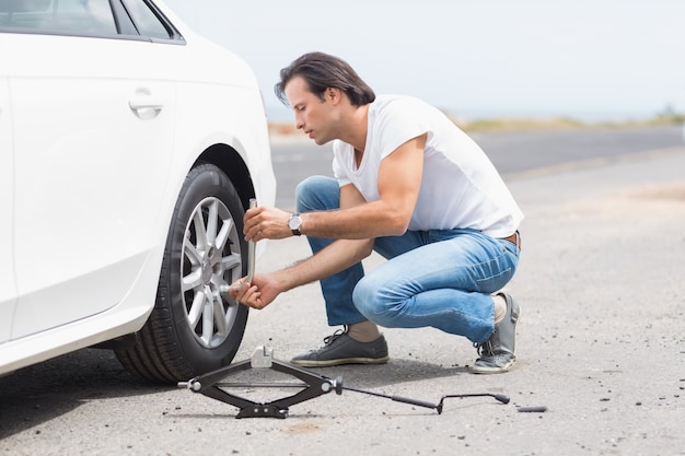 Man changing wheel after a car breakdown 