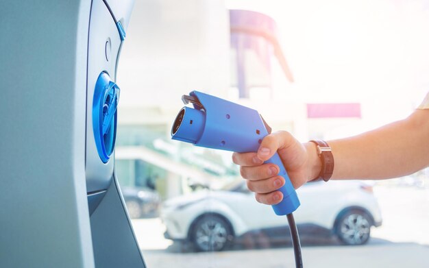 Man charge his electric car at city charging station