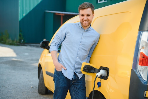 Man charges an electric car at the charging station