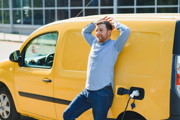 Man charging his electric car at charge station