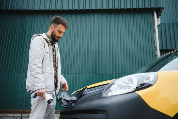 Man charging his electric car