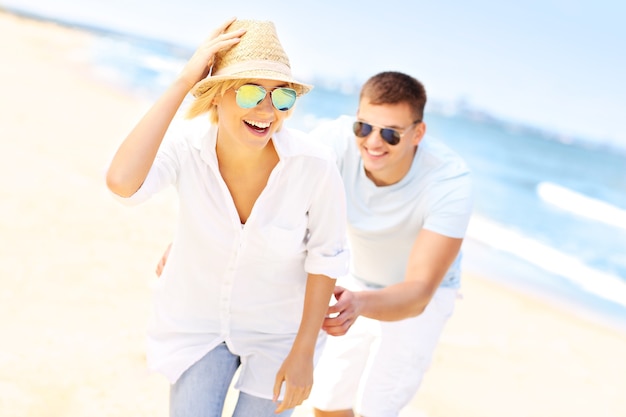 man chasing a woman at the beach