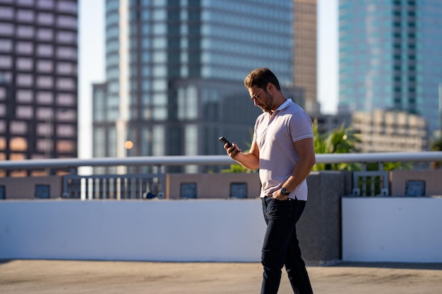 Man chatting on phone on the street handsome confident man talking on phone outside business phone c