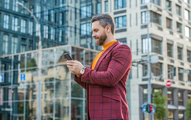 man chatting on smartphone outdoor man chatting on smartphone in the street