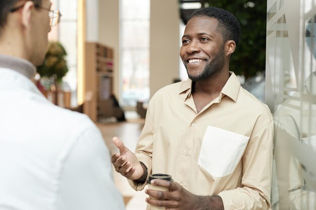 Man chatting with colleague during break