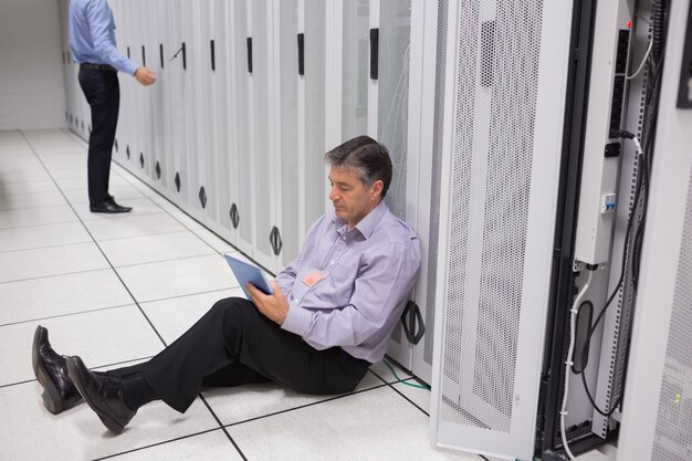 Man checking the data store with the tablet pc