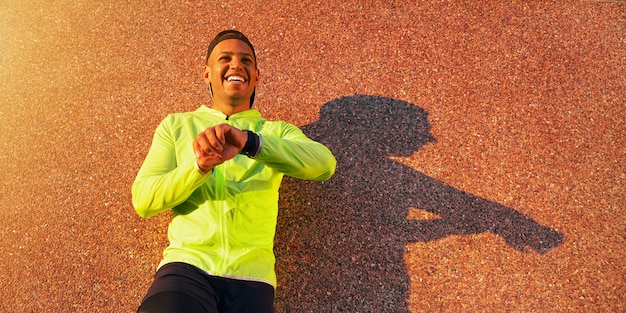 Man checking his watch while exercising in the city Healthy lifestyle