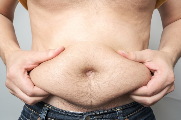 Man checking his weight isolated