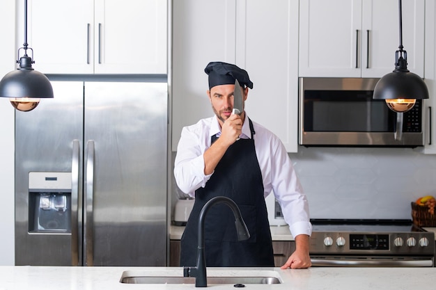 Man in chef apron cooking on kitchen