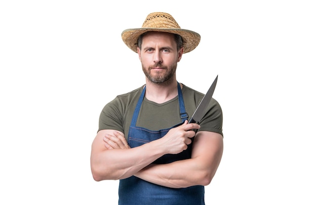 Фото Шеф-повар в фартуке и шляпе держит нож на белом фоне