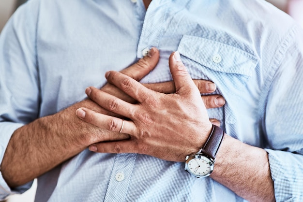 man chest and hands on heart attack in home breathing pain and cardiac emergency or heartburn male person angina disease and nervous or anxiety ache in living room stress and cardiology injury