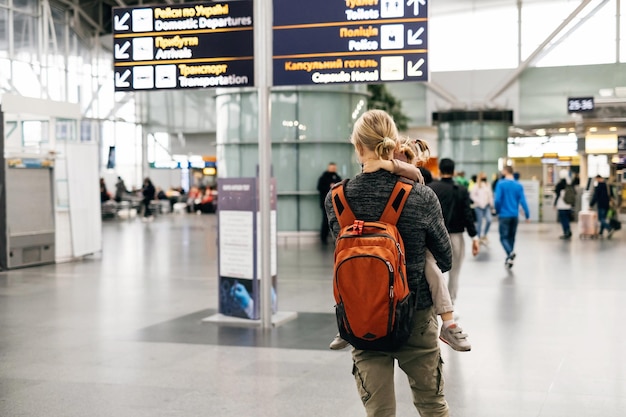 man and child at the airport with backpack
