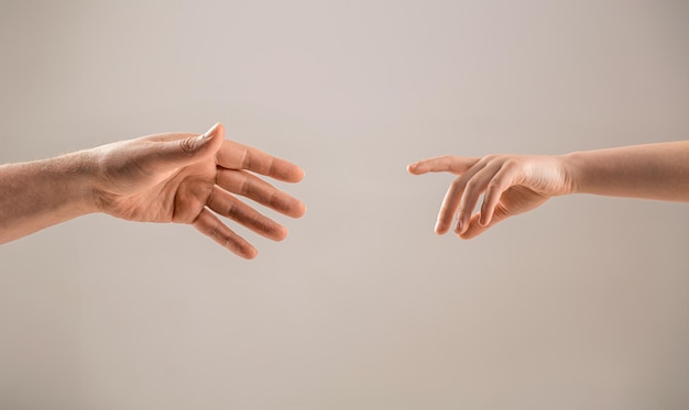 Man and children hands reach toward each other Child and father hands isolated