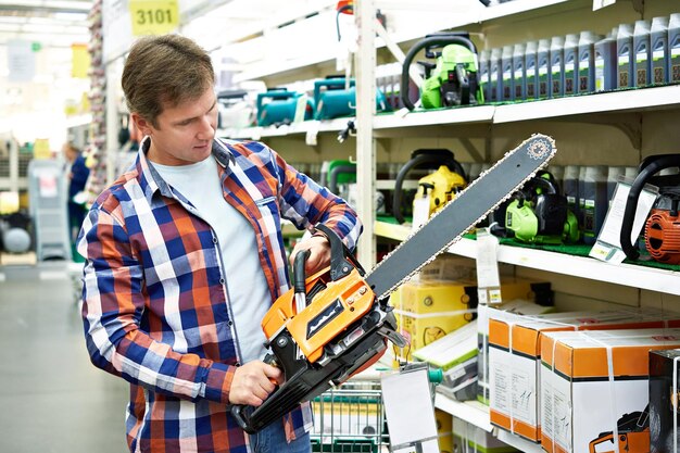 Photo man chooses gasoline saw