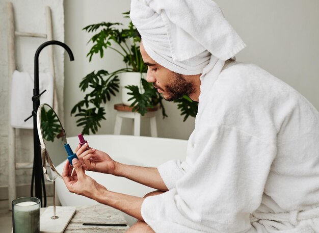 Man choosing colour of varnish for manicure