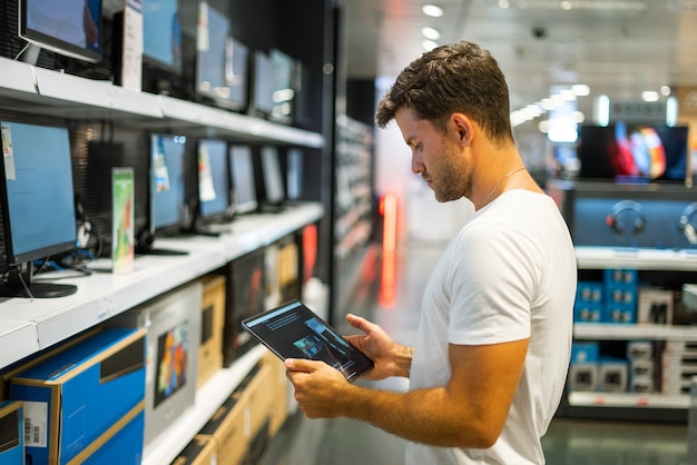 Man choosing monitor in shop