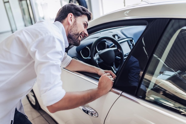 man choosing new car