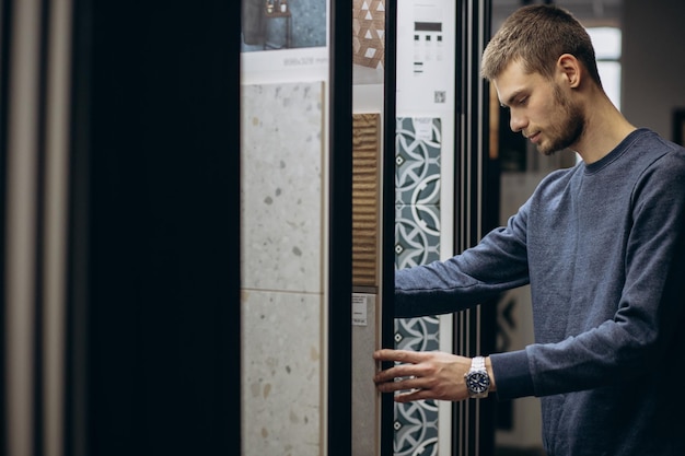 Man choosing tiles at building market