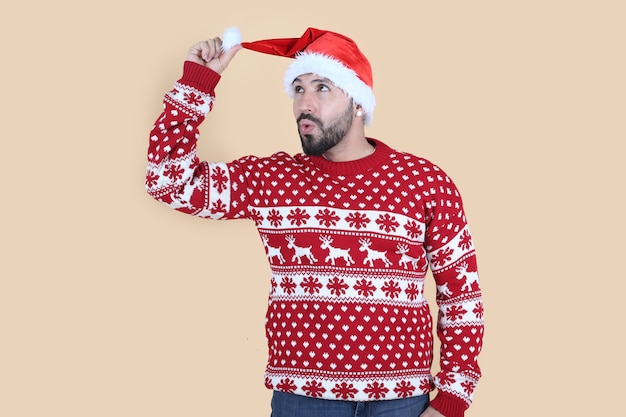 man at christmas with santa hat yellow background