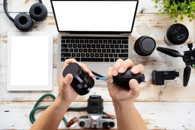 Man Cleaning Camera Lens Element