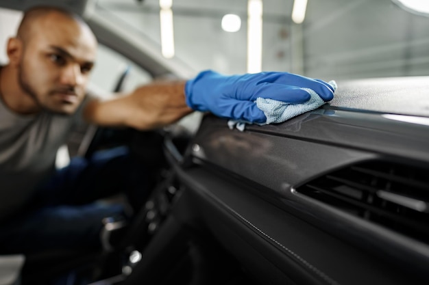 A man cleaning car interior car detailing in carwash service