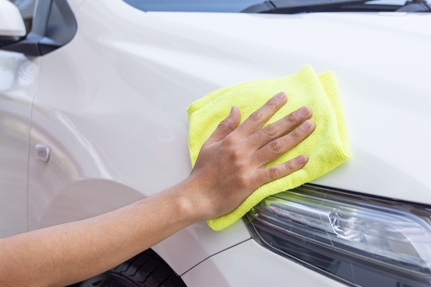 Man cleaning car with microfiber cloth