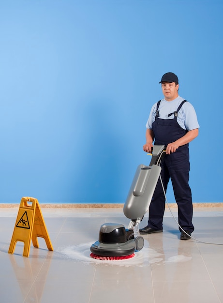 man cleaning floor with machine