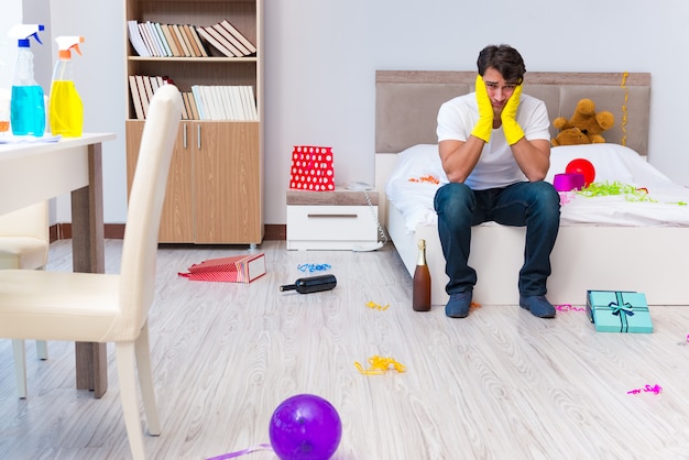 Man cleaning the house after christmas party