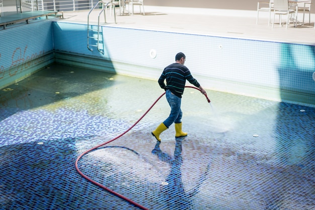 A man cleaning pool