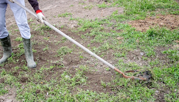 A man cleans weeds in the garden spring cleaning on the farm
selective focus