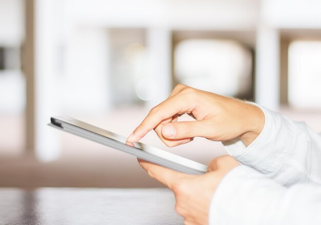 Man clicks on a digital tablet