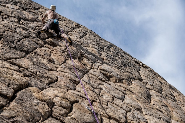 Man climbing on a very weird rock