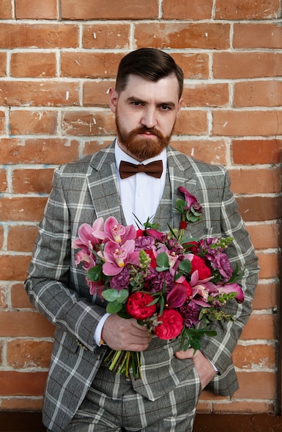 Man Clothed Stylish Suit Holding Bouquet of Flower