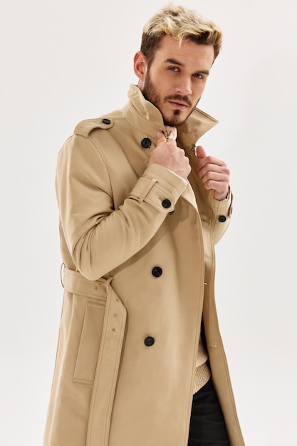 A man in a coat holding a collar autumn style fashion