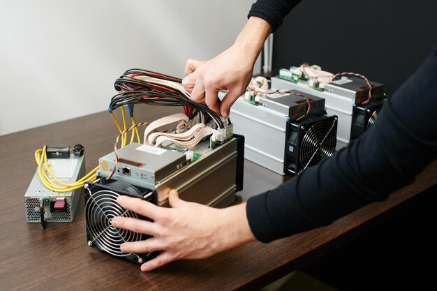 A man collects equipment for the extraction of cryptocurrency bitcoin