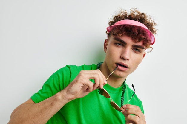 Man in colored glasses posing on white