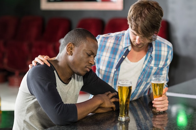 Man comforting his friend