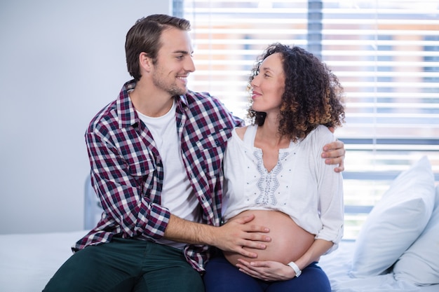 Man comforting pregnant woman in ward