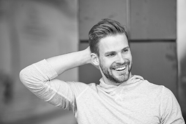 Man confident in his antiperspirant Prevent reduce perspiration No sweat deodorant works Guy checks dry armpit satisfied with clean clothes Sportsman after training pleased with antiperspirant