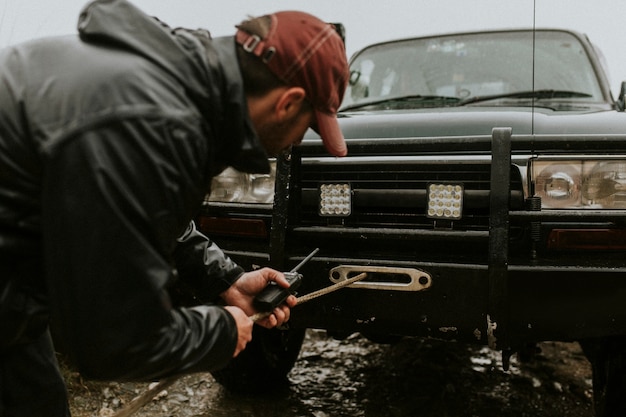 Man connecting the car towing cable