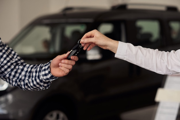 the man considers a new model range of cars and tries to choose the best for himself.