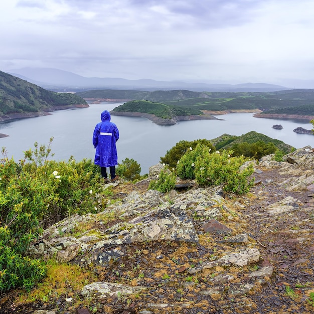 雨の日に山の風景を考えている男