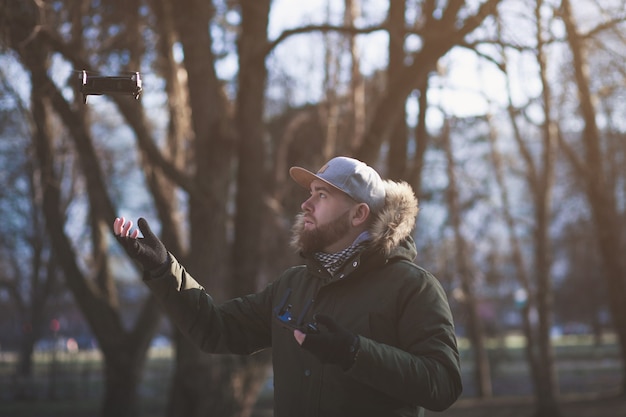 Man controls in cap flying drones spring