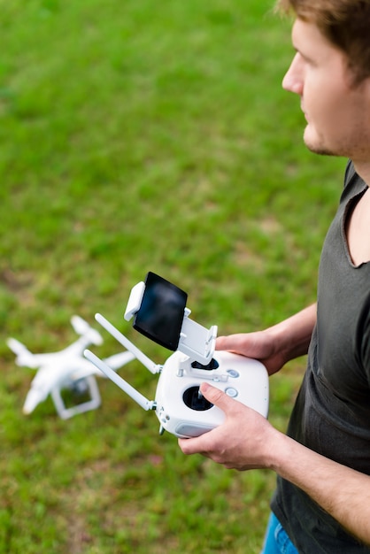 Man controls the drone in the city outdoors