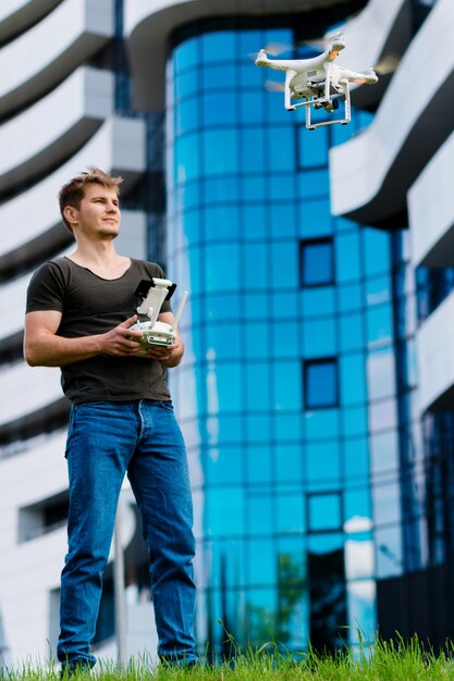 Man controls the drone in the city